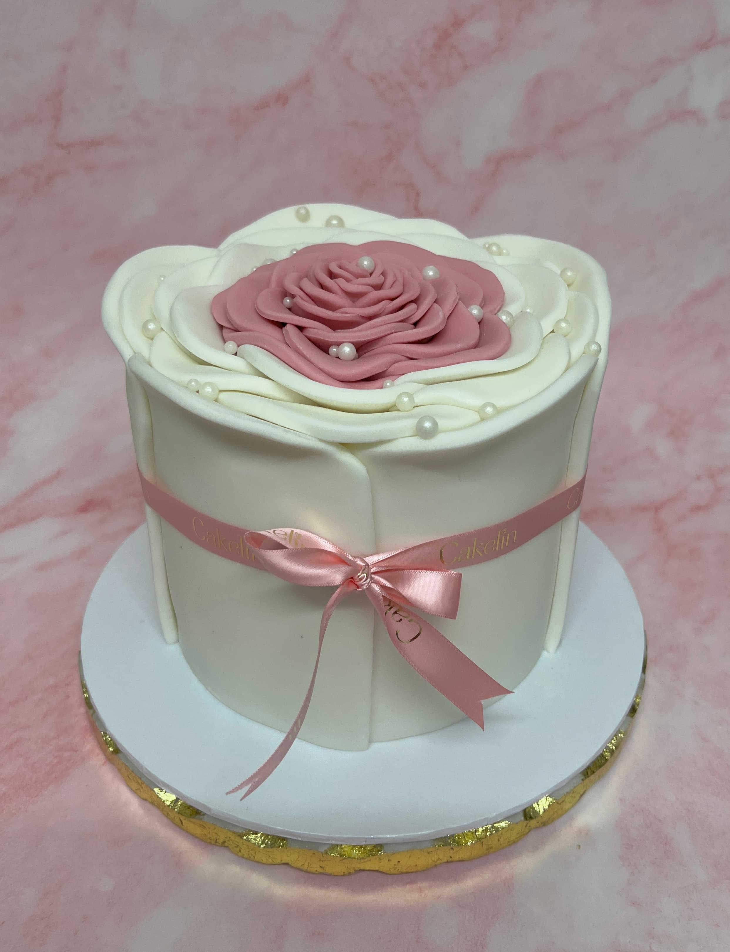A handcrafted Cakelin rose celebration cake